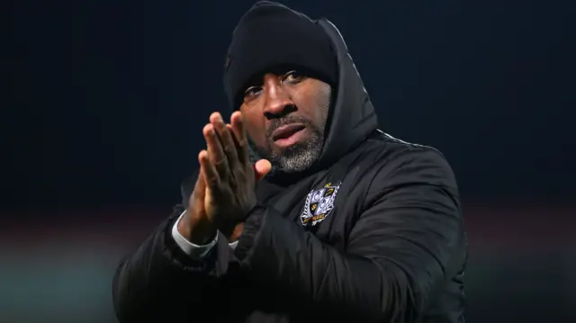 Port Vale manager Darren Moore applauds