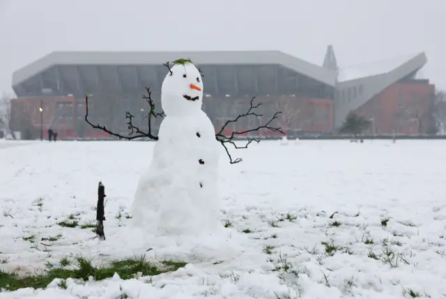 Snowman stands outside Anfield