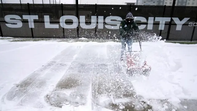 One man attempts to clear snow in St Louis