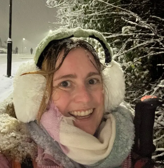 A selfie Rachel Hubbard has taking holding a hiking pole - snow can be seen in the background