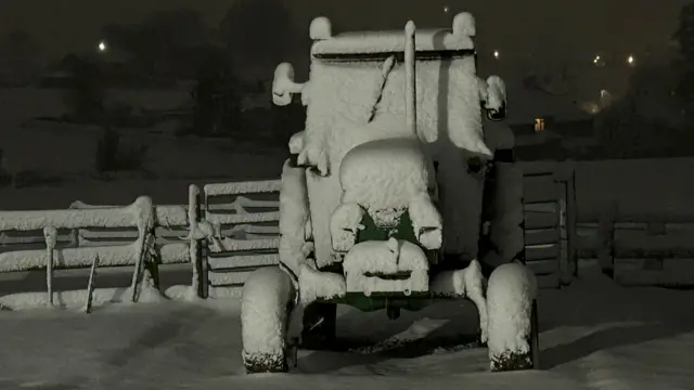 A snow covered tractor