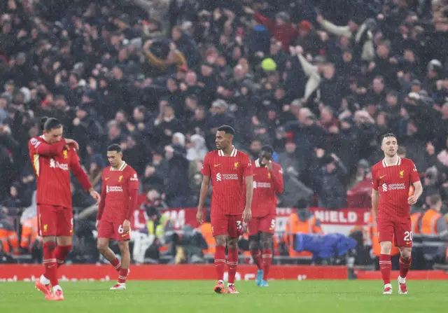 Liverpool players trudge to kick off