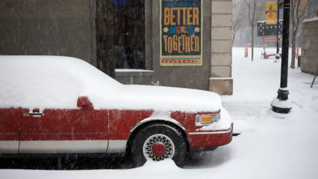 A snow-covered stretch limousine sits parked on January 5, 2025 in downtown Louisville, Kentucky