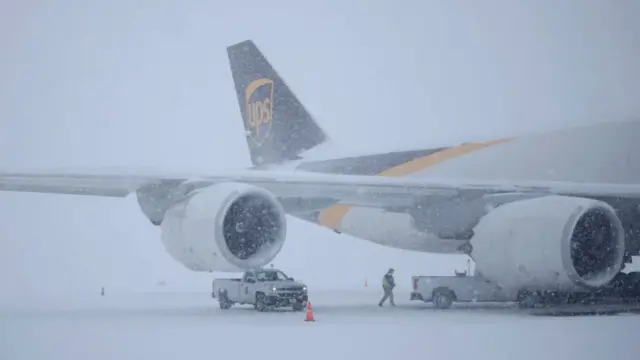 A United Parcel Service, Inc. (UPS) Boeing 747 cargo jet sits parked in the snow