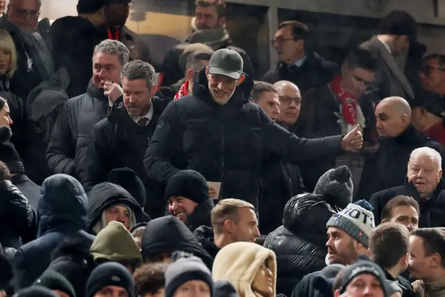 Thomas Tuchel makes his way to his seat in the stands