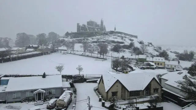 Snow blankets fields and buildings in Cashel, Ireland