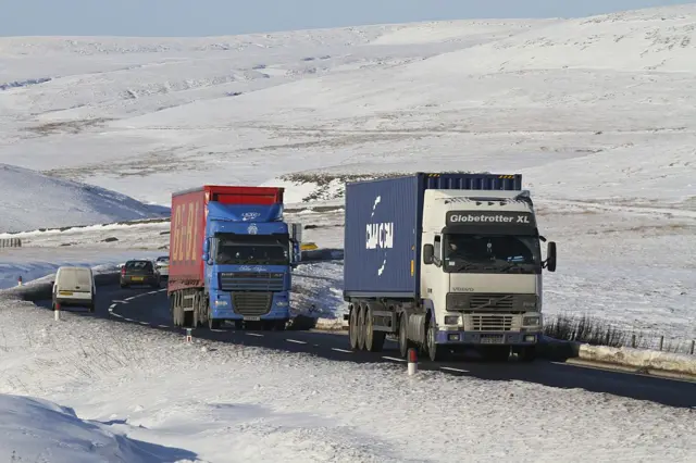 Archive shot of lorries and cars on a snowy Woodhead Pass