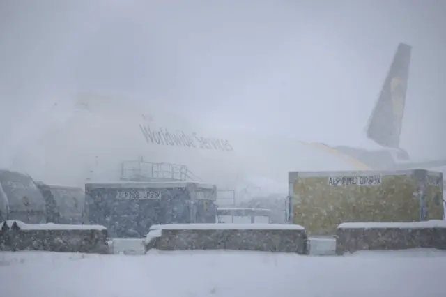 A United Parcel Service (UPS) Boeing 747 cargo jet sits parked in the snow at Louisville international airport