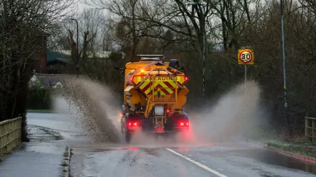 A spreader vehicle drives through standing water in Upton upon Severn, Worcestershire