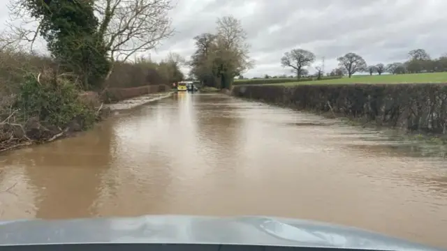 View of flooded road as seen from car