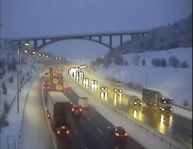 Traffic slowing in snowy conditions on the M62