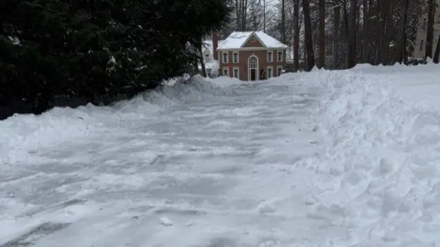 The road by Matthew's home is coated in ice after the snow melted