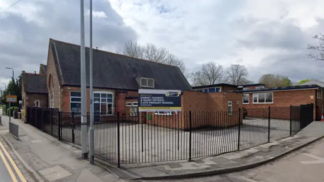 A school building behind a railing