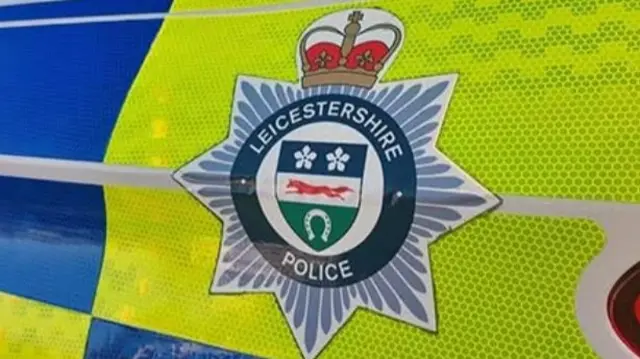 A force crest  on the side of a police car