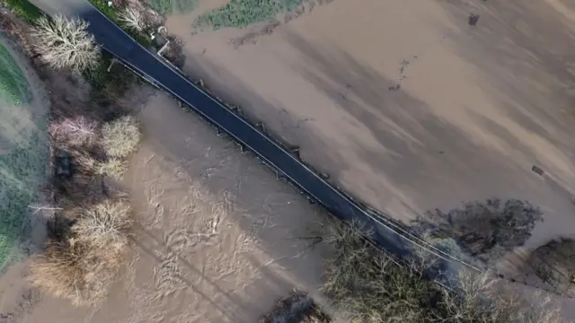 Bridge surrounded by muddy water from flood