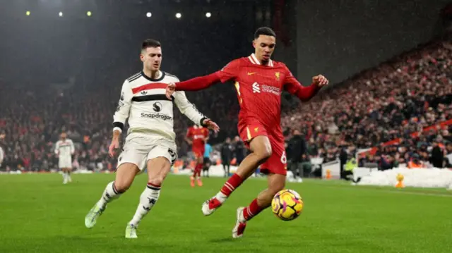 Trent Alexander-Arnold of Liverpool is challenged by Diogo Dalot of Manchester United