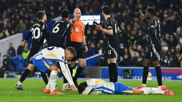 Joao Pedro reacts following a foul as referee Anthony Taylor gives a penalty to Brighton