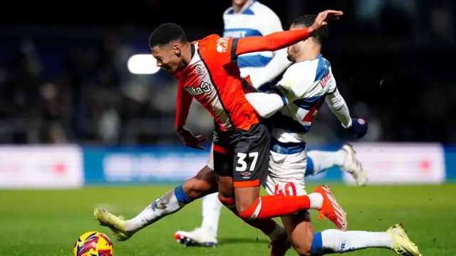 Jonathan Varane brings down Luton's Zack Nelson