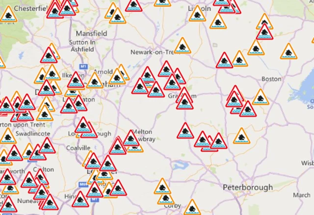 A map of the East Midlands with red amber triangles marking flood warnings and alerts