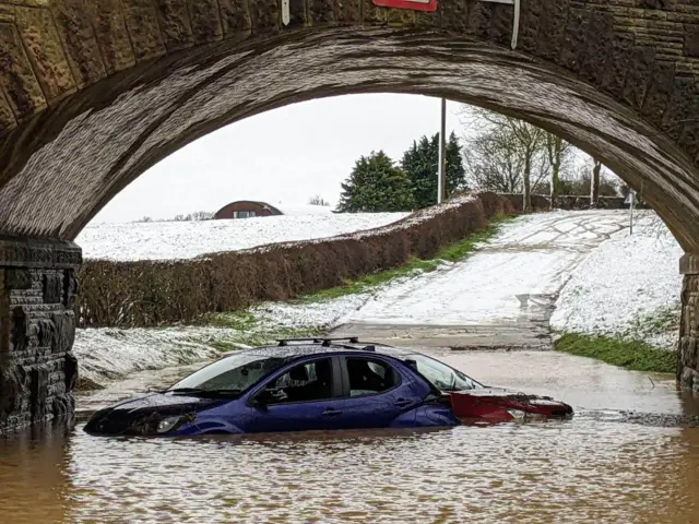 Two cars stranded in flood water