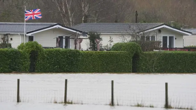 Flood water rising at caravan park