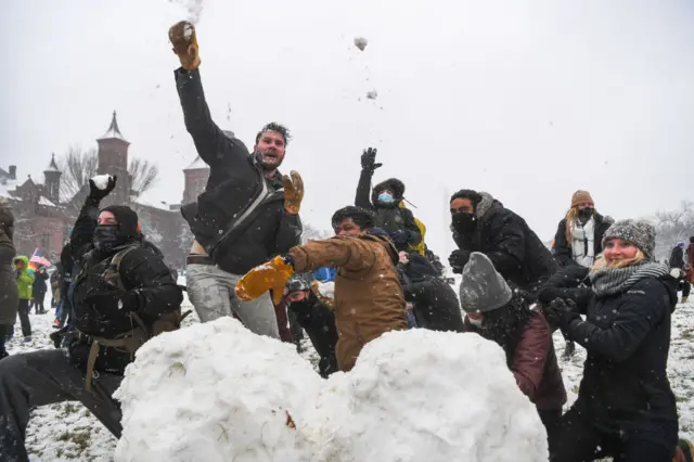 People throw snowballs during a snowball fight organised by the D.C. Snowball Fight Association in 2021