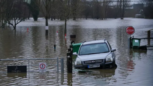 Grey car caught in flood