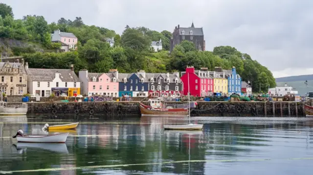 Multi-coloured houses overlook the harbour on Mull