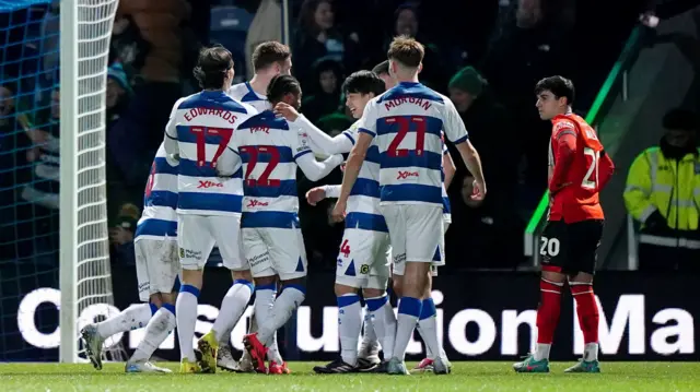 QPR players celebrate with Morgan Fox