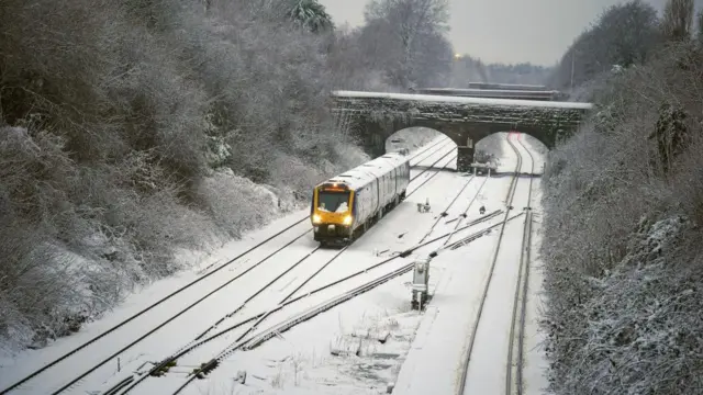 A train makes its way along the Hunt's Cross line in Liverpool