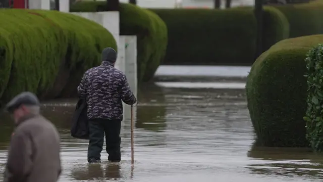 Person walking through flood, with water up to their ankles