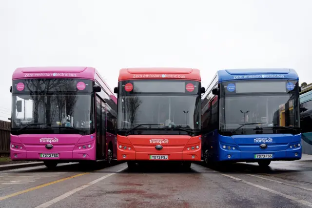 Three colorful Nottingham City Transport buses next to eachother