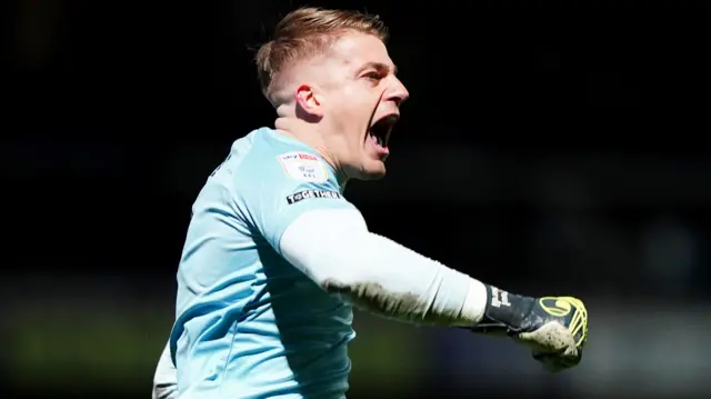 QPR goalkeeper Paul Nardi celebrates at full-time after victory over Luton