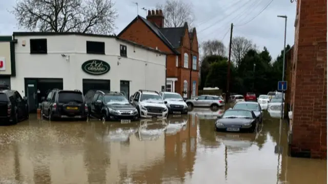 Cars parked in flood water in Great Glen