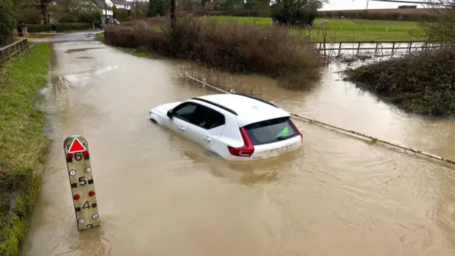 Volvo car submerged in flood water