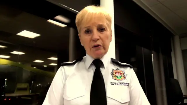 Beresford, wearing a white shirt bearing the Leicestershire Fire and Rescue Service logo and a black tie, speaks to the camera