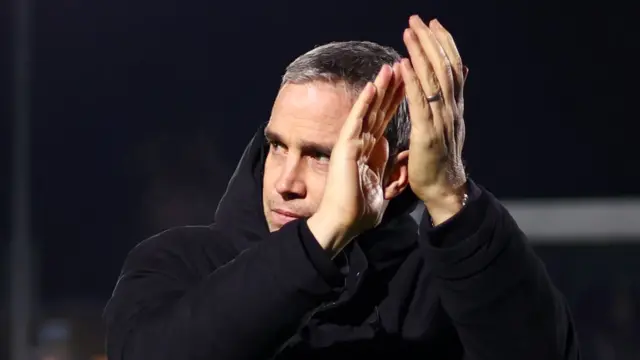 Huddersfield manager Michael Duff claps the travelling support