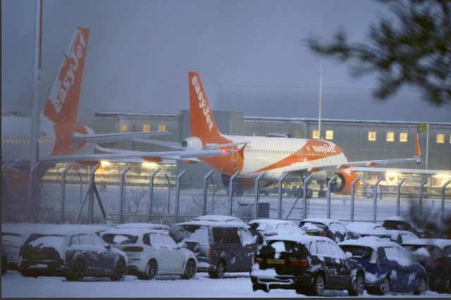 Easyjet planes parked on a snow-covered runway