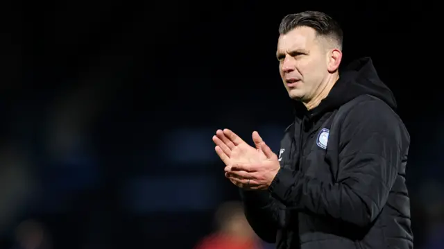 Wycombe manager Matt Bloomfield claps fans after the full-time whistle