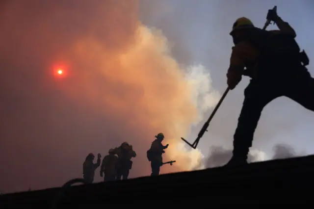 A silhouette of a firefighter