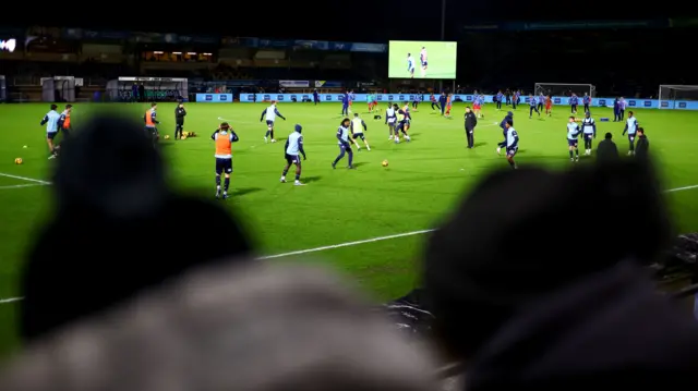 Wycombe players warm up at Adams Park