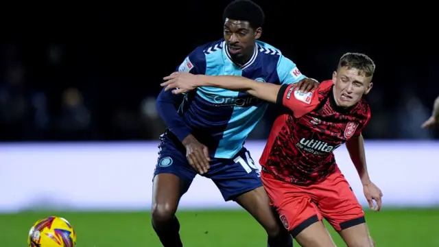 Wycombe's Tyreeq Bakinson battles with Huddersfield's Callum Marshall