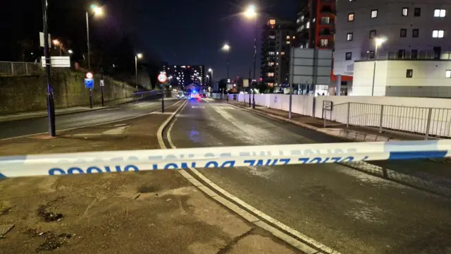 Police tape blocks off access to a main road in London