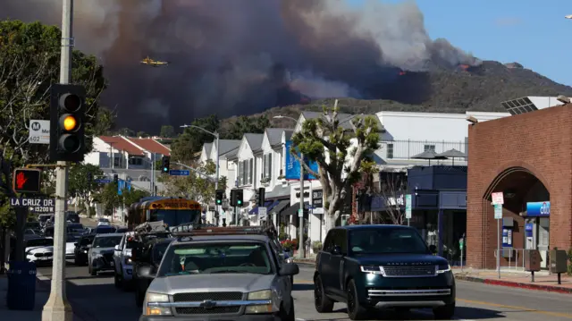 Smoke rises from a wildfire burning near Pacific Palisades on the west side of Los Angeles during a weather driven windstorm, in Los Angeles