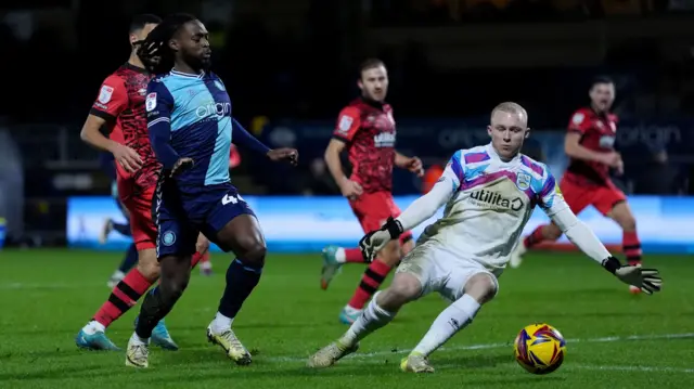 The ball runs away from Wycombe's Fred Onyedinma