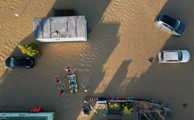 A man is rescued from the flooding at a caravan park near Barrow upon Soar, Leicestershire