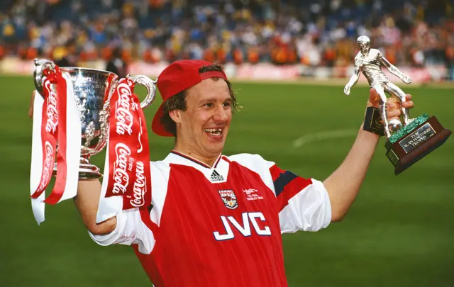 Paul Merson with the League Cup trophy and Man of the Match award for Arsenal