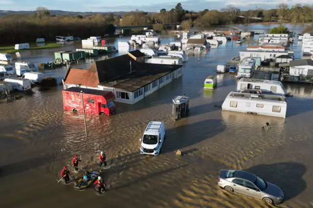 A man is rescued from the flooding at a caravan park near Barrow upon Soar, Leicestershire.