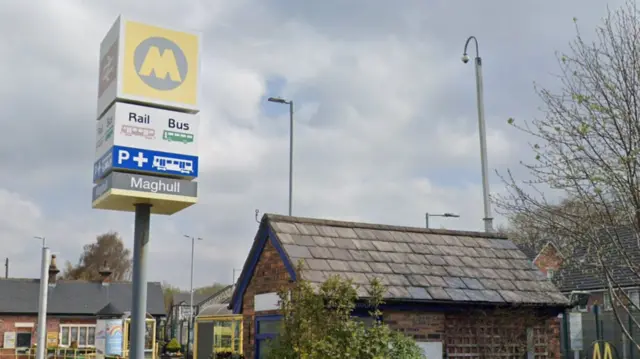 Maghull railway station sign showing rail and bus services