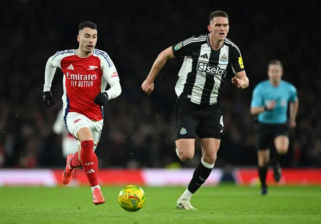 Gabriel Martinelli of Arsenal runs for the ball under pressure from Sven Botman